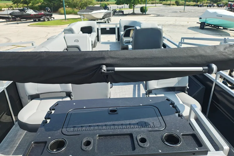 Slide: The Image of 2027 Sun Tracker SportFish 22 DLX pontoon boat interior with seating and fishing station. - 27