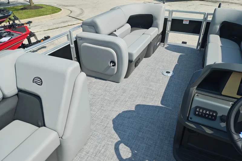 Slide: The Image of 2027 Sun Tracker SportFish 22 DLX pontoon boat interior with gray seating and modern dashboard. - 29
