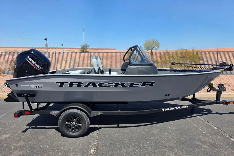 The Image of 2027 Tracker Pro Guide V-16 WT boat on trailer, parked outdoors. - 0