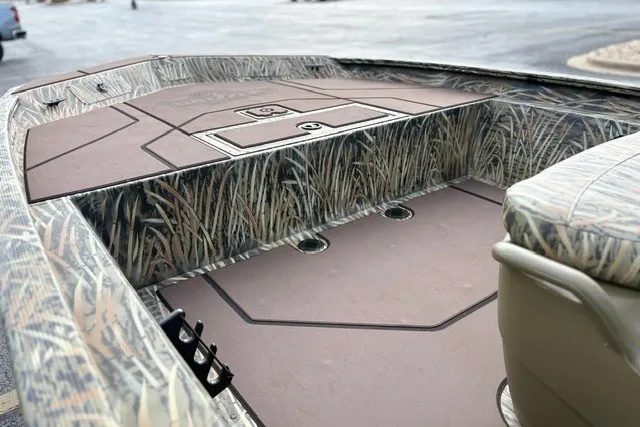 Slide: The Image of 2027 Tracker Grizzly 1860 CC boat interior with camouflage design and spacious deck. - 13