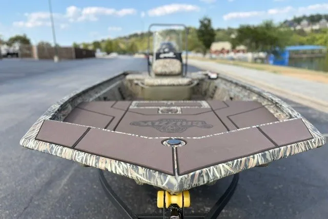 Slide: The Image of 2027 Tracker Grizzly 1860 CC boat with camouflage design on a sunny day. - 17