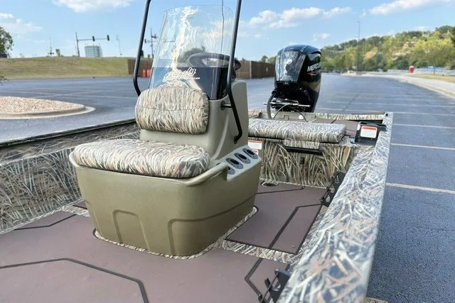 Slide: The Image of 2027 Tracker Grizzly 1860 CC boat with camouflage seating and Mercury outboard motor. - 20