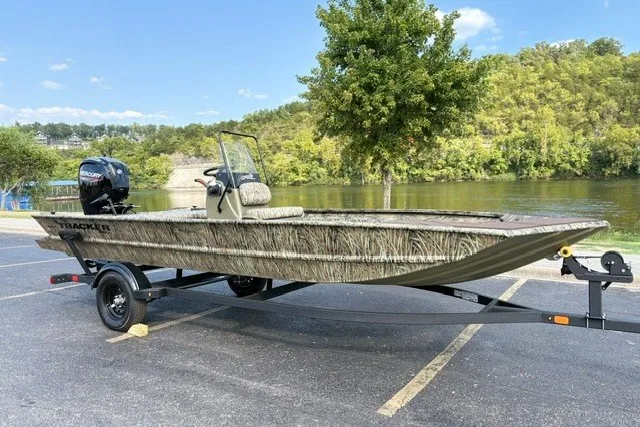 Slide: The Image of 2027 Tracker Grizzly 1860 CC boat on trailer by a scenic river. - 18