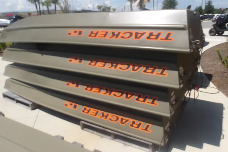 The Image of Stacked 2027 Tracker Grizzly 12 Jon boats on display outdoors. - 0