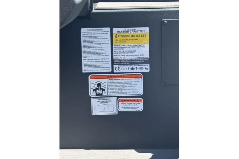 Slide: The Image of Safety and capacity labels on a 2027 Tracker Pro 170 boat dashboard. - 13