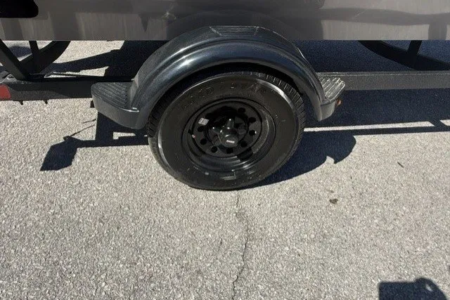 Slide: The Image of Trailer wheel of a 2027 Tracker Pro 170 on asphalt pavement. - 14
