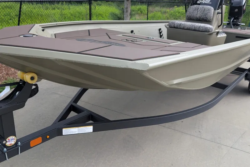 The Image of 2027 Tracker Grizzly 1860 CC boat on trailer, featuring a spacious deck and seating. - 0