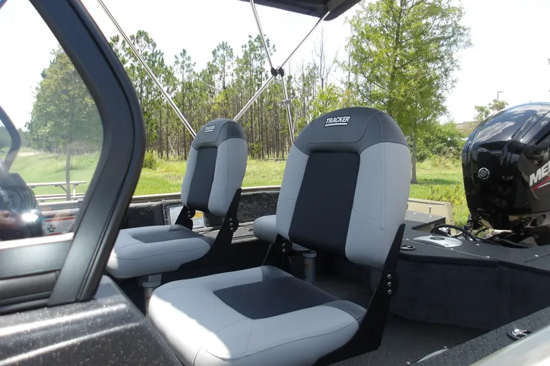 Slide: The Image of 2027 Tracker Pro Guide V-16 WT boat interior with two cushioned seats and visible motor. - 15