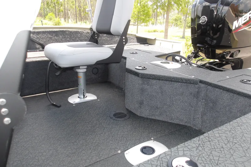 Slide: The Image of Interior of 2027 Tracker Pro Guide V-16 WT boat with seating and motor. - 16