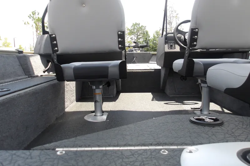 Slide: The Image of 2027 Tracker Pro Guide V-16 WT boat interior with gray seating and steering wheel. - 18