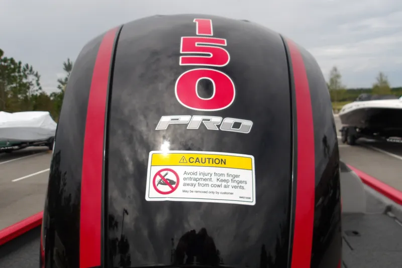 Slide: The Image of Outboard motor of 2027 Tracker Pro Team 195 boat with caution label and red stripes. - 14