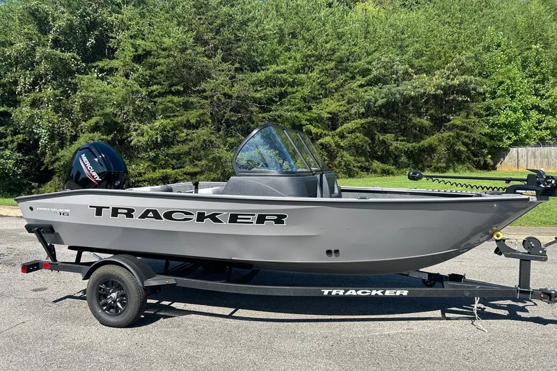 The Image of 2027 Tracker Pro Guide V-16 WT boat on trailer, parked outdoors. - 0