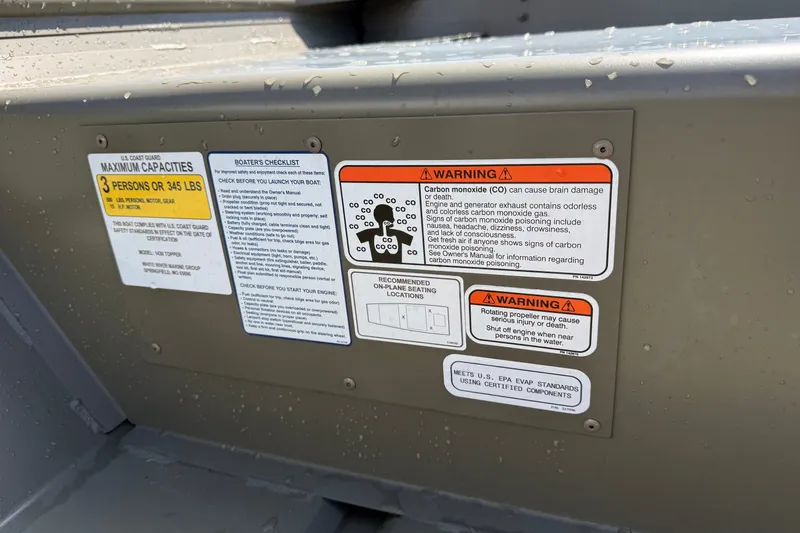 Slide: The Image of Warning labels and capacity information on a 2027 Tracker Grizzly 12 Jon boat. - 35