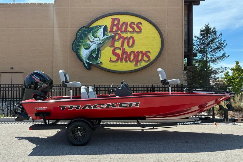 The Image of Red 2027 Tracker Pro Team 190 boat displayed outside Bass Pro Shops. - 0