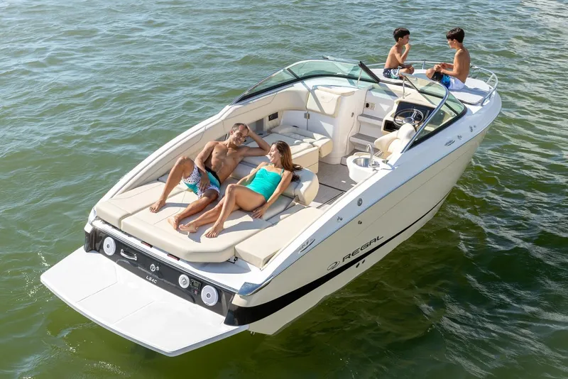 Slide: The Image of Manufacturer Provided Image: 2026 Regal LS4C boat with people relaxing on deck in sunny waters. - 3