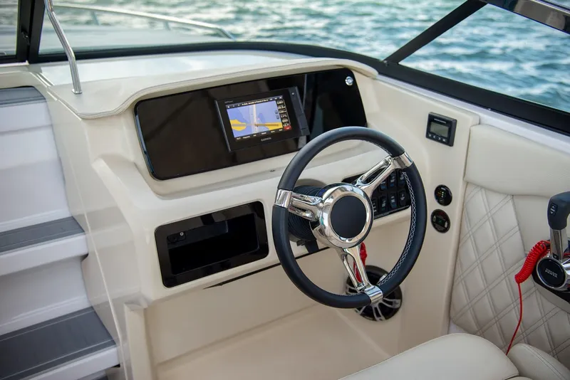 Slide: The Image of Manufacturer Provided Image: 2026 Regal LS4C boat cockpit with modern steering wheel and navigation display. - 7
