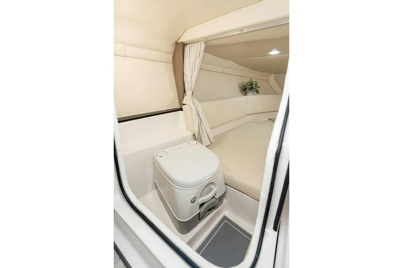 Slide: The Image of Manufacturer Provided Image: 2026 Regal LS4C cabin interior with compact toilet and cozy seating area. - 13