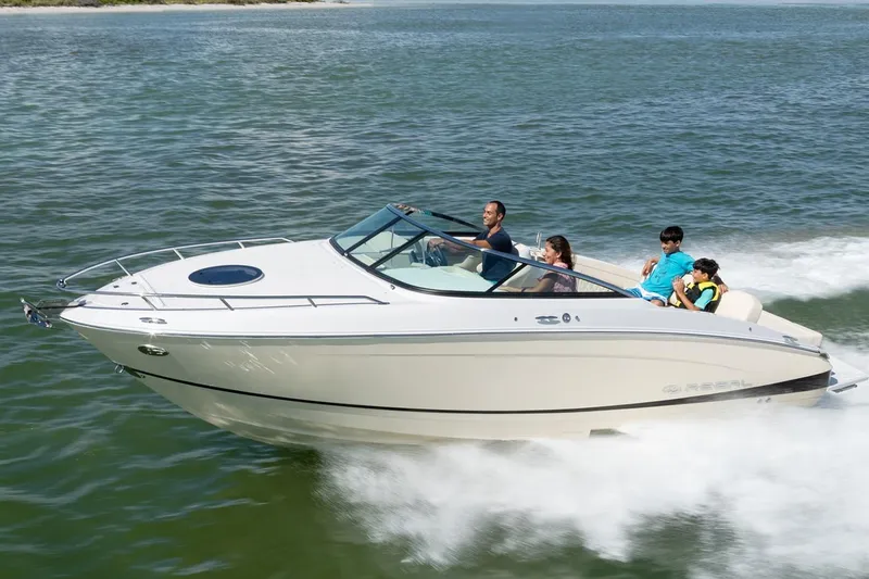 Slide: The Image of Manufacturer Provided Image: 2026 Regal LS4C boat cruising on open water with passengers enjoying the ride. - 0