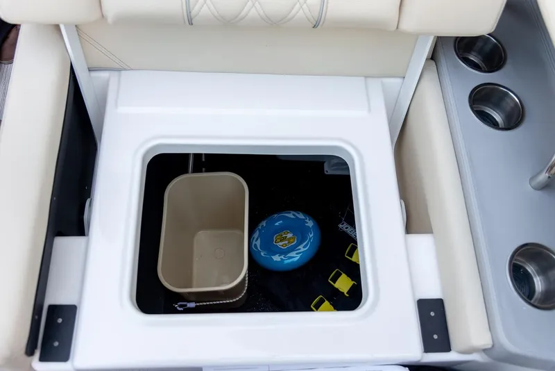 Slide: The Image of Manufacturer Provided Image: Storage compartment in 2026 Regal LS4C boat with cup holders and accessories. - 11