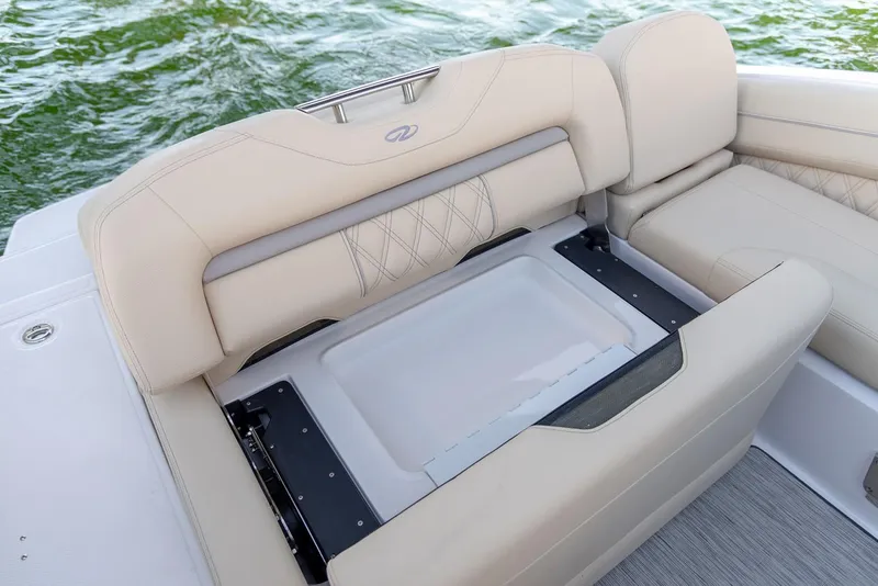Slide: The Image of Manufacturer Provided Image: Luxurious seating on 2026 Regal LS4C boat with integrated storage, on calm water. - 9