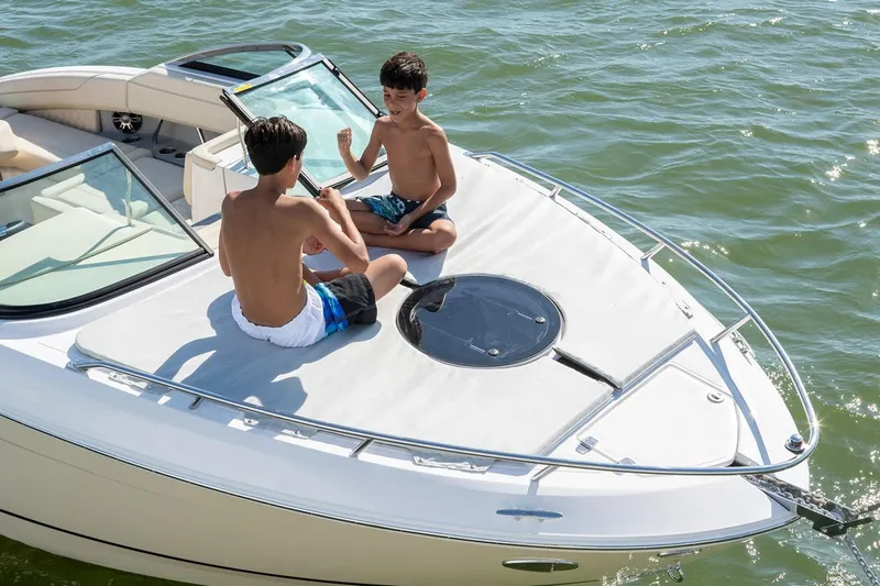 Slide: The Image of Manufacturer Provided Image: Two children sitting on a 2026 Regal LS4C boat, enjoying the sunny day. - 4