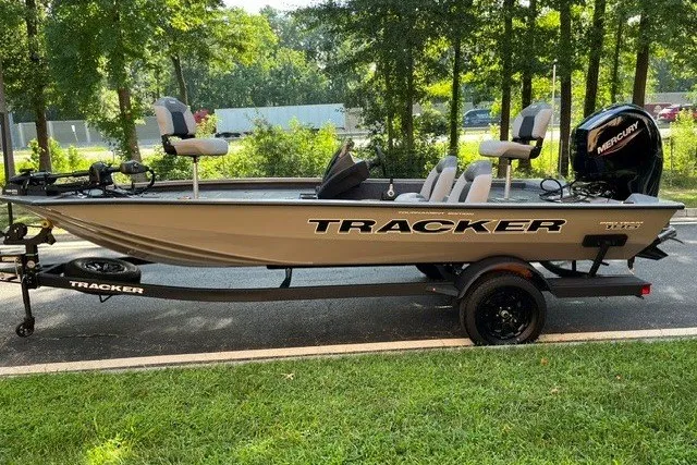 The Image of 2027 Tracker Pro Team 195 boat on trailer, parked outdoors, with Mercury engine. - 0