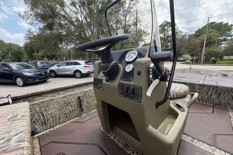 Slide: The Image of 2027 Tracker Grizzly 1860 CC boat console with steering wheel and gauges. - 66