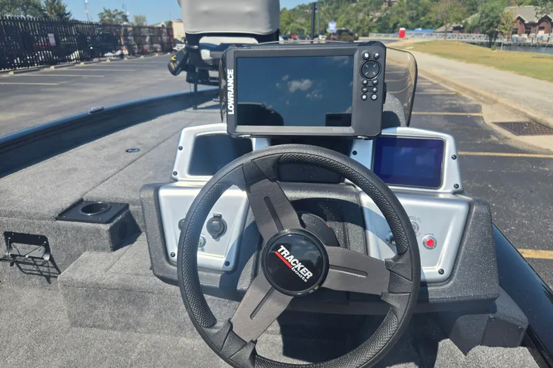 Slide: The Image of 2027 Tracker Pro Team 190 boat dashboard with steering wheel and Lowrance fishfinder. - 13