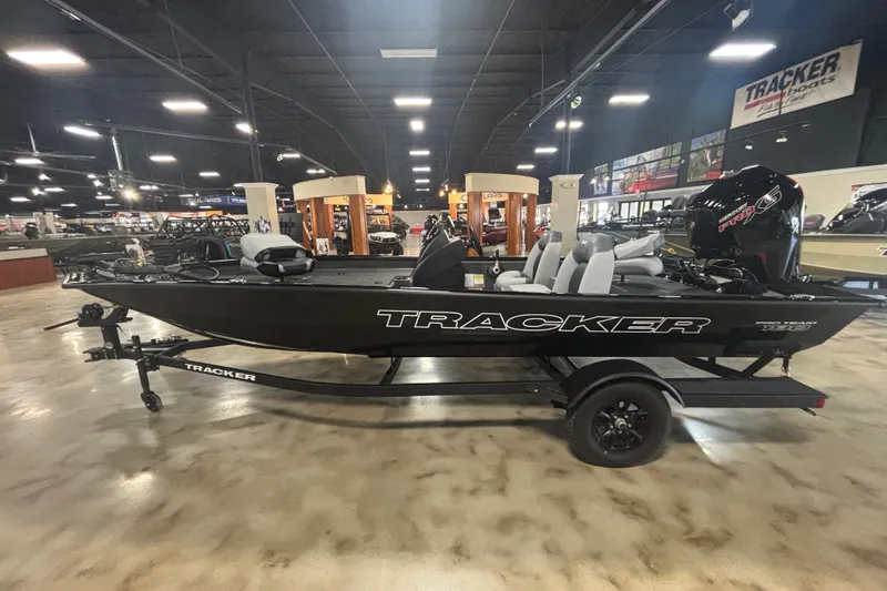 The Image of 2027 Tracker Pro Team 190 boat displayed in a showroom, featuring sleek black design. - 1