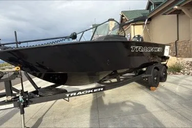 The Image of 2027 Tracker Targa V-18 Combo boat on trailer, parked near a building. - 0