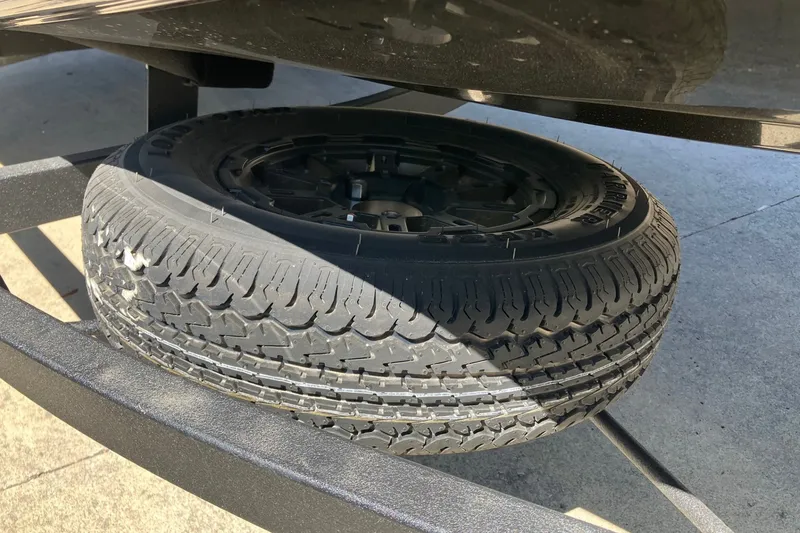 Slide: The Image of Spare tire mounted on a 2027 Tracker Pro Team 190 boat trailer. - 16