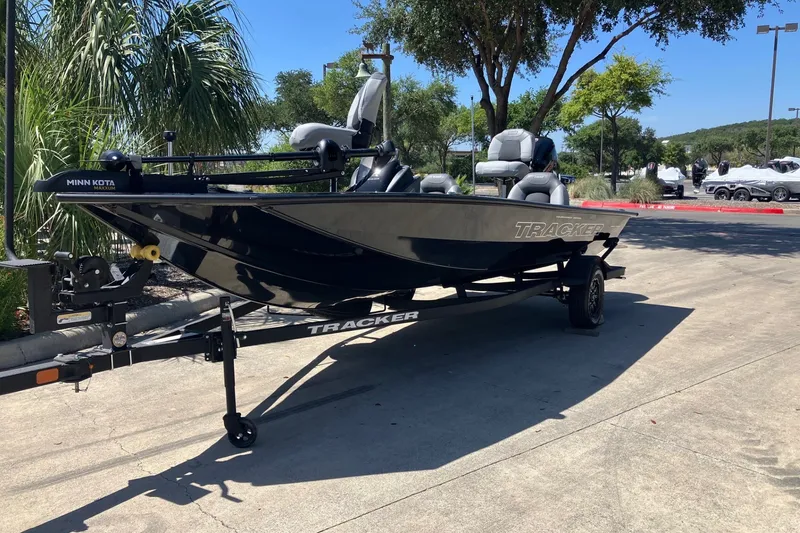 The Image of 2027 Tracker Pro Team 190 boat on trailer, parked outdoors under sunny skies. - 0