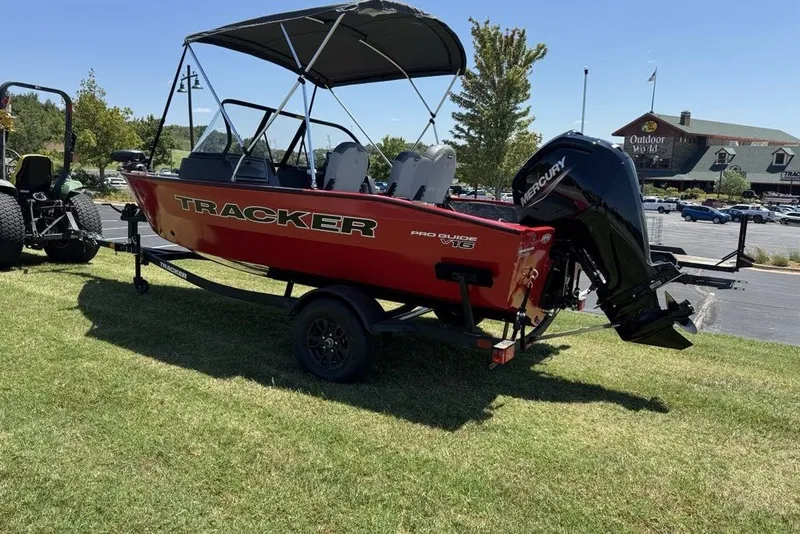 The Image of 2027 Tracker Pro Guide V-16 WT boat with Mercury engine on display outdoors. - 0