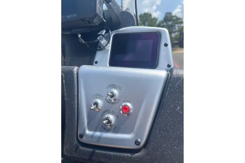 Slide: The Image of Control panel of 2027 Tracker Pro Team 195 boat with switches and display screen. - 16