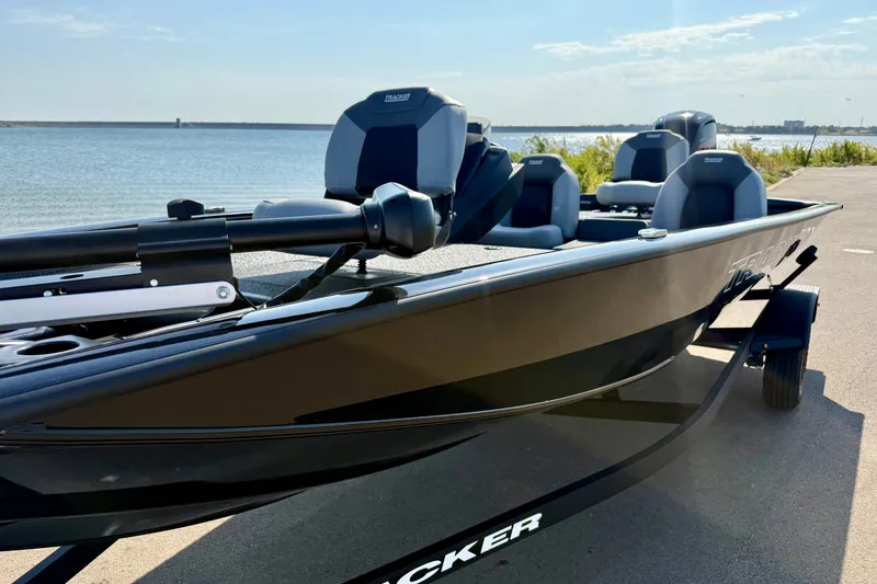 Slide: The Image of 2027 Tracker Pro Team 190 boat on trailer by the water, sunny day. - 14