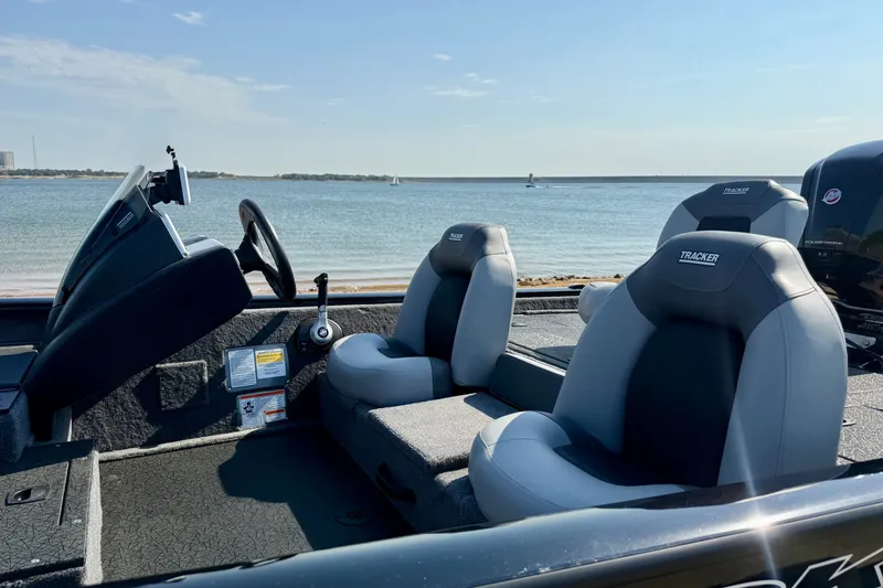 Slide: The Image of 2027 Tracker Pro Team 190 boat interior with lake view in background. - 17