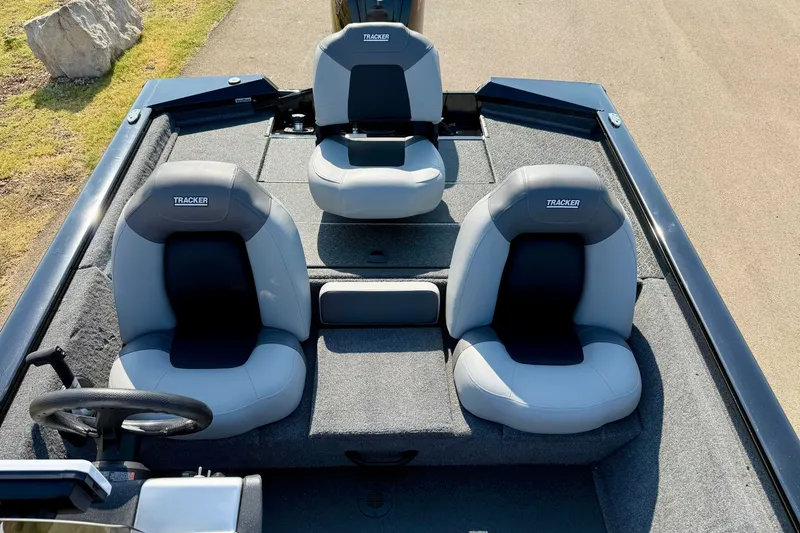 Slide: The Image of 2027 Tracker Pro Team 190 boat interior with three gray seats and steering wheel. - 16