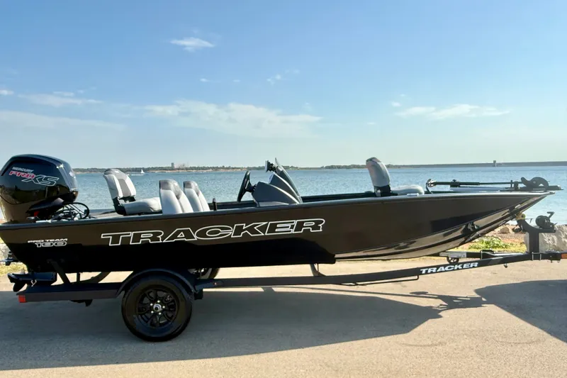 The Image of 2027 Tracker Pro Team 190 boat by the water on a trailer. - 0