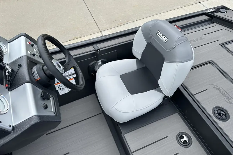 Slide: The Image of 2027 Tracker Pro 170 boat interior with steering wheel and cushioned seat. - 16