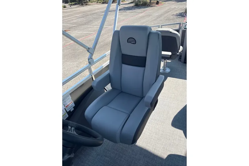 Slide: The Image of 2027 Sun Tracker SportFish 22 DLX boat seat, gray upholstery, outdoor setting. - 13