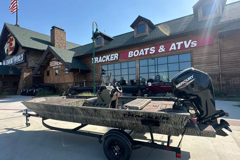The Image of 2027 Tracker Grizzly 1860 CC boat outside Bass Pro Shops, featuring Mercury engine. - 1