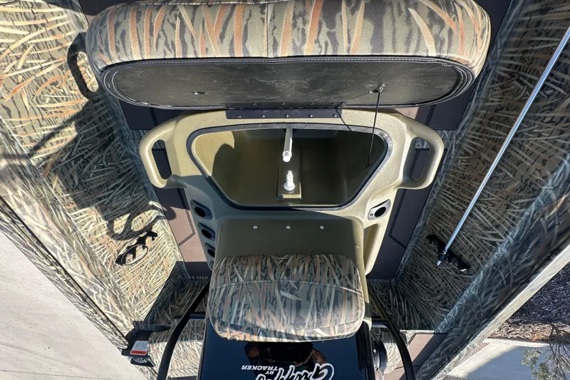 Slide: The Image of 2027 Tracker Grizzly 1860 CC boat interior with camouflage seating and storage compartment. - 15
