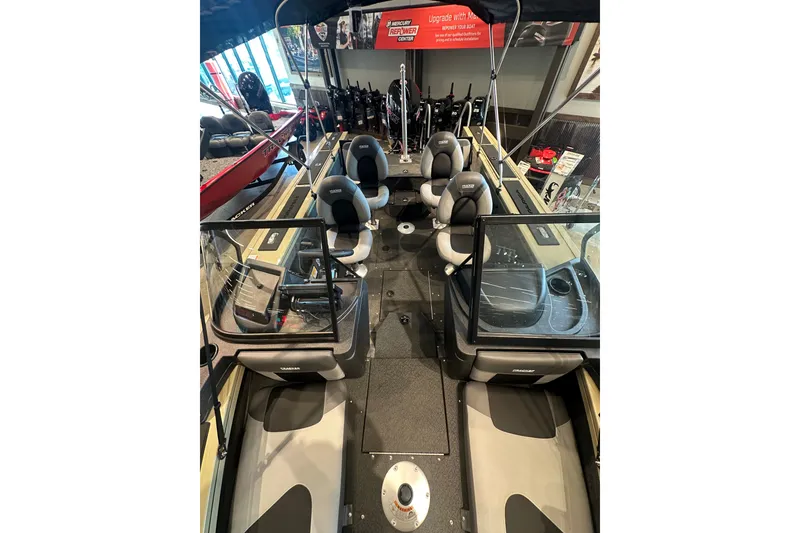 Slide: The Image of 2027 Tracker Targa V-18 Combo boat interior with seating and windshield in showroom. - 28