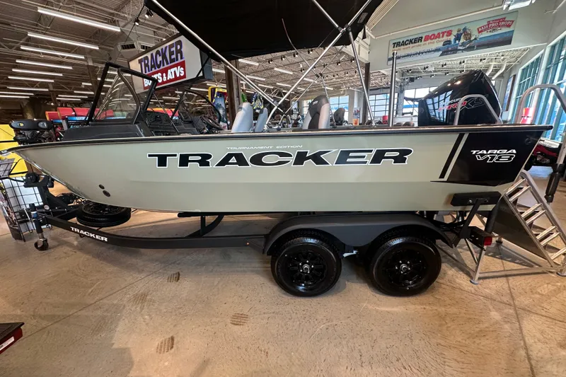 The Image of 2027 Tracker Targa V-18 Combo boat displayed indoors on a trailer. - 1