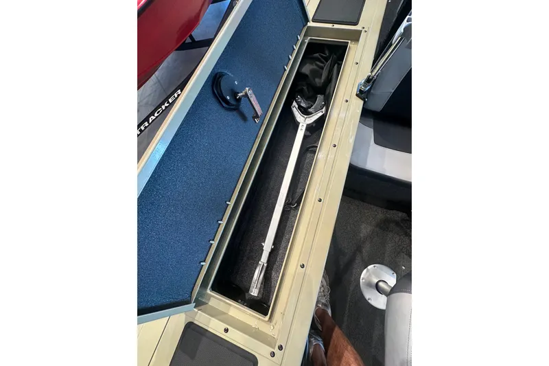 Slide: The Image of Storage compartment in 2027 Tracker Targa V-18 Combo boat, featuring a fishing net. - 29