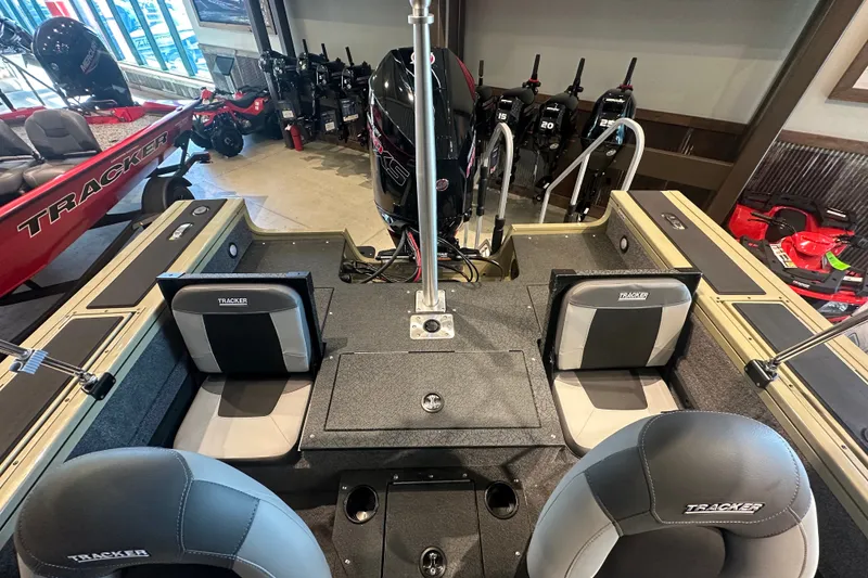 Slide: The Image of 2027 Tracker Targa V-18 Combo boat interior with seating and motor display. - 14