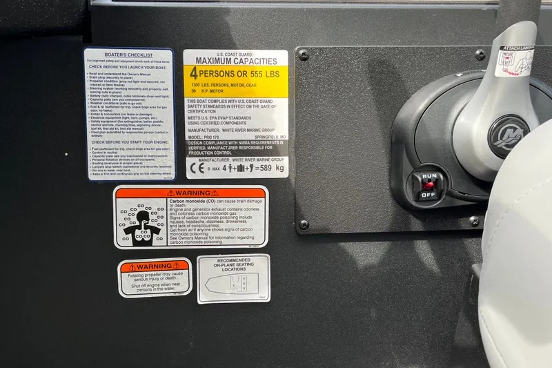 Slide: The Image of Boat dashboard with safety labels and controls, Tracker Pro 170, 2027 model. - 13