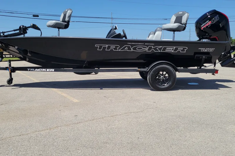 The Image of 2027 Tracker Pro Team 190 boat on trailer in parking lot. - 0