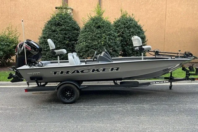 The Image of 2027 Tracker Pro Team 190 fishing boat on trailer, parked outdoors. - 0