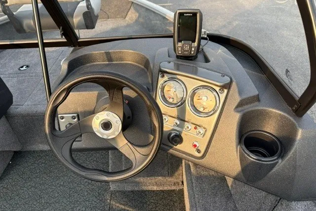 Slide: The Image of 2027 Tracker Pro Guide V-16 WT dashboard with steering wheel and gauges. - 60